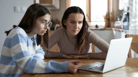 Daughter and mother looking at a computer screen