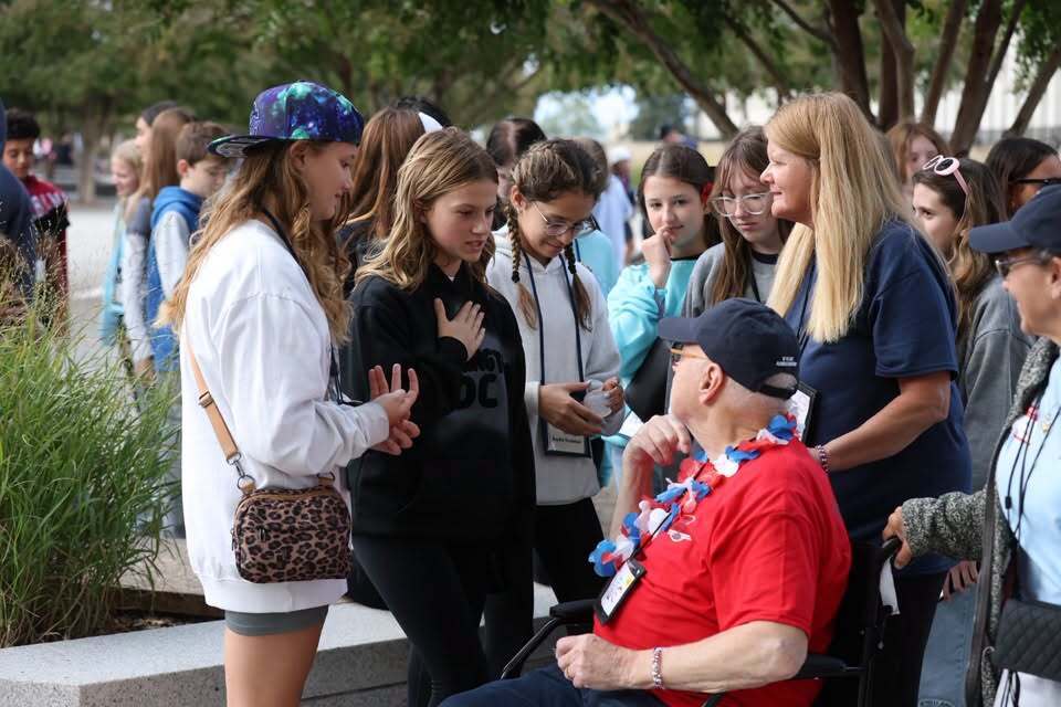Students speaking with a veteran at the Buffalo Niagara Honor Flight 