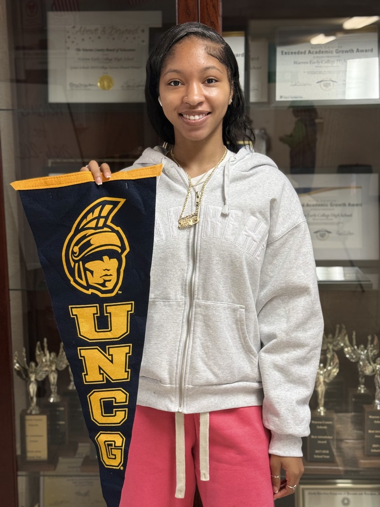 Jakyra holding UNCG flag