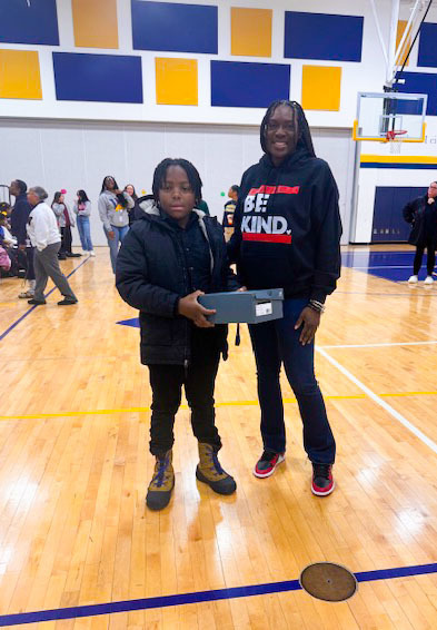 student receiving a prize for attendance 