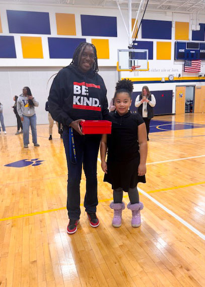 student receiving a prize for attendance 