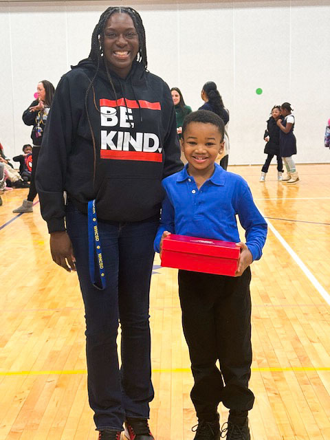 student receiving a prize for attendance 