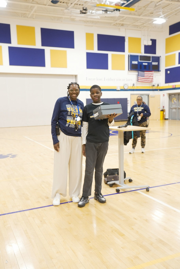 student receiving a prize for attendance 