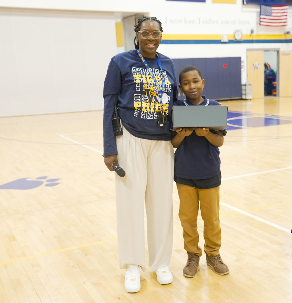 student receiving a prize for attendance 