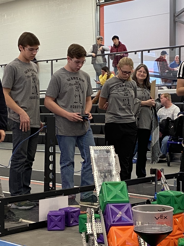 3 robotic students at tournament