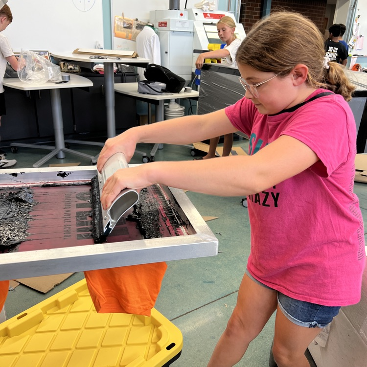Students are making their shirts for the upcoming cardboard boat race  