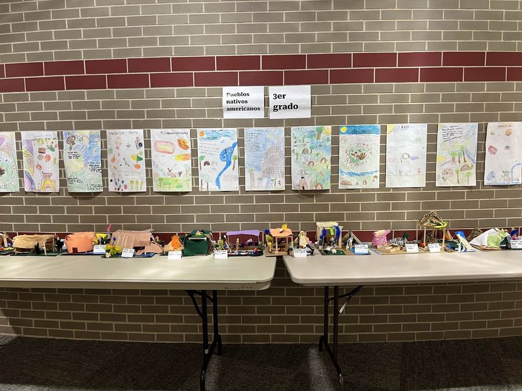 A display of student projects about different types of Native American homes, with drawings and models.