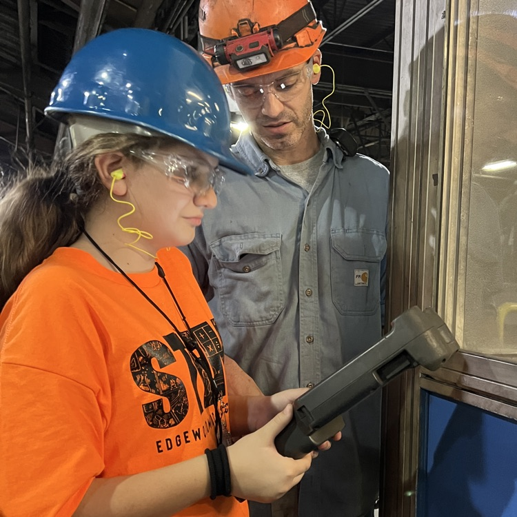 Students tour and operate a robot at Dalton Foundry. 