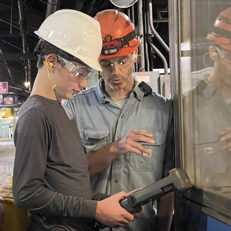 Students tour and operate a robot at Dalton Foundry. 