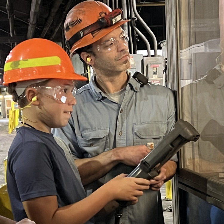 Students tour and operate a robot at Dalton Foundry. 
