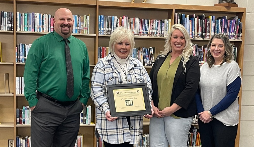 Warsaw Flower Shop accepts award.