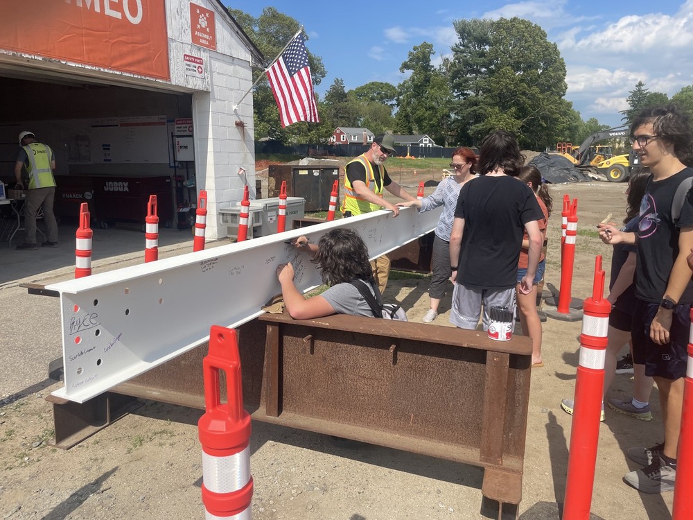 Pilgrim students sign the new high school's final steel beam