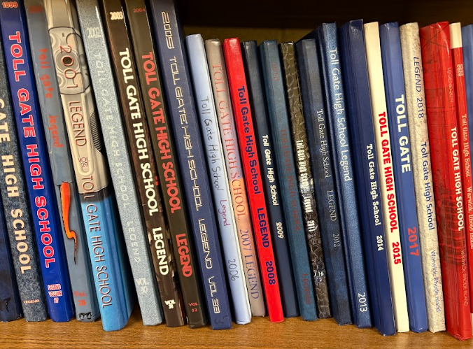 About 20 Toll Gate High School yearbooks on a shelf