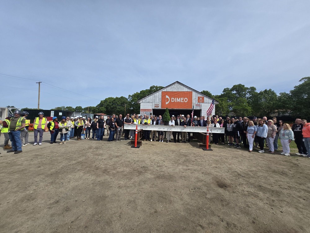 Warwick School officials and staff with the final steel beam at the new school's topping off ceremony
