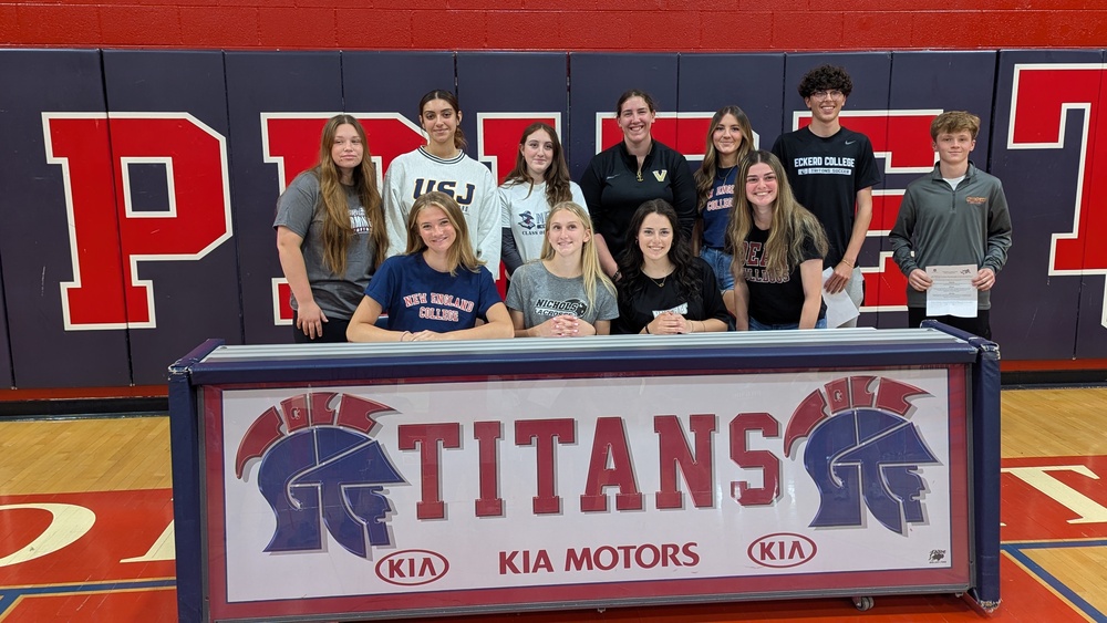student athletes wearing their college jerseys on signing day