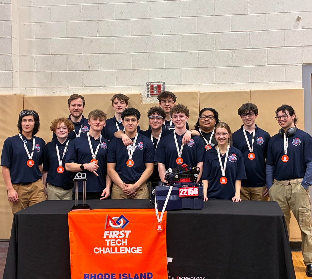 Robo-Titan team posing with their medals, robot and trophy