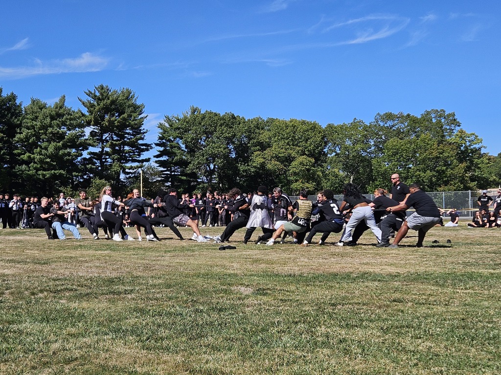 Students playing tug of war in the field