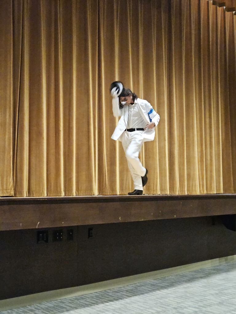 Student dressed as Michaels Jackson in white suit with hat and silver glove