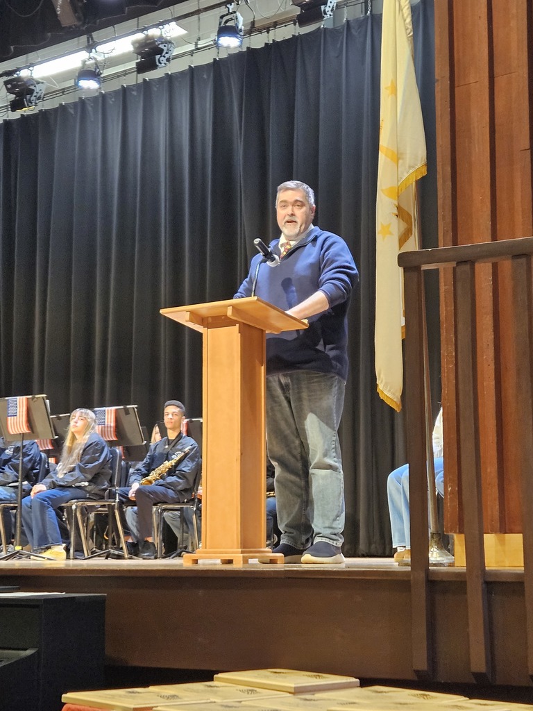 English teacher Brian Callahan speaking at the podium