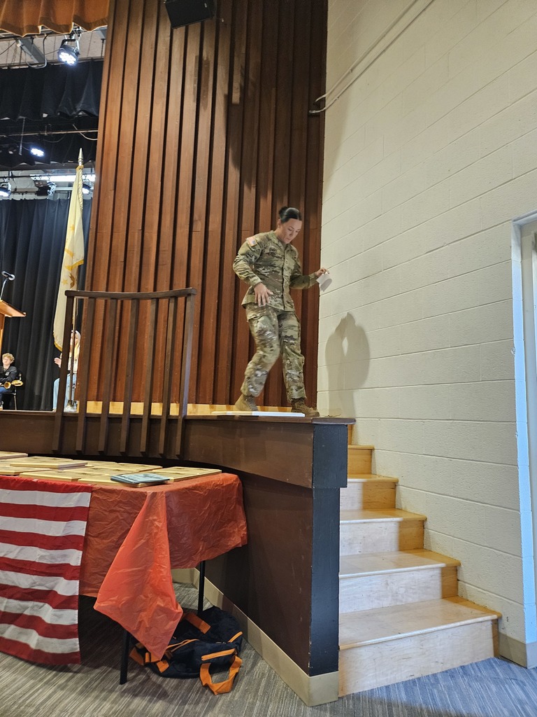 Private Makayla Lyndes walking down the stage stairs