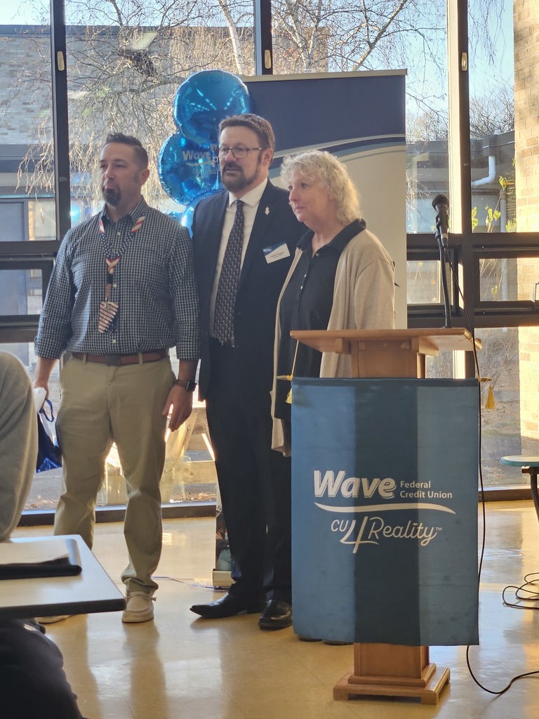 Business teachers and WAVE President at podium