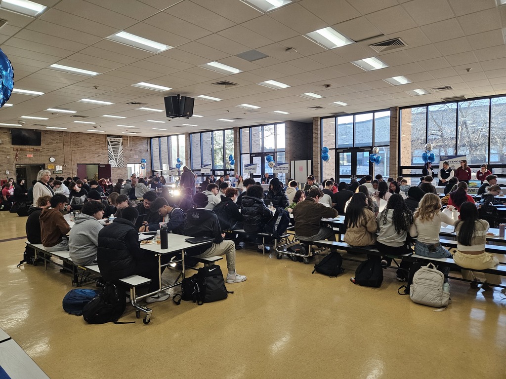 Students sitting in cafeteria waiting for the literacy fair