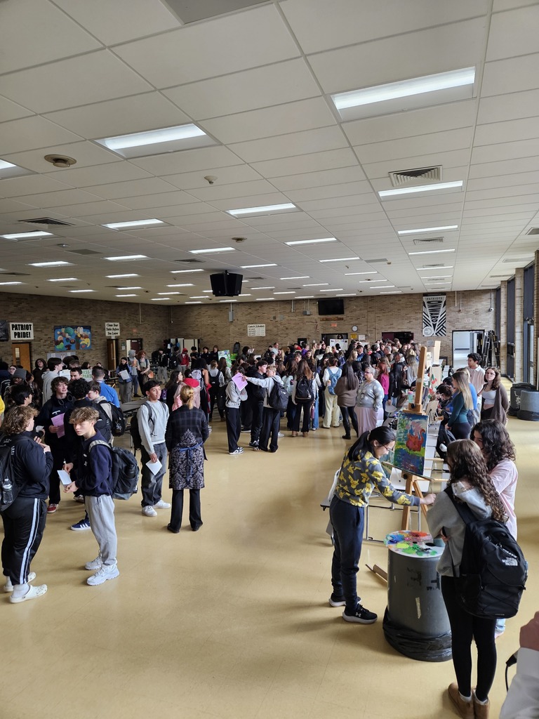 room full of students looking at posters about classes