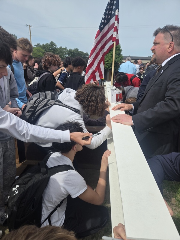 Students signed the steel beam under the watchful eye of Pilgrim Principal Toby Gibbons.