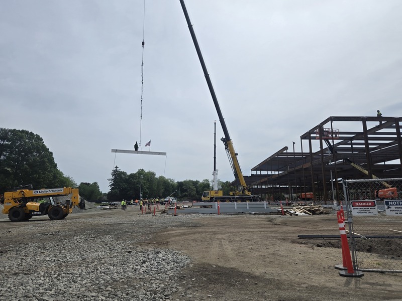 The beam is craned from the ground.
