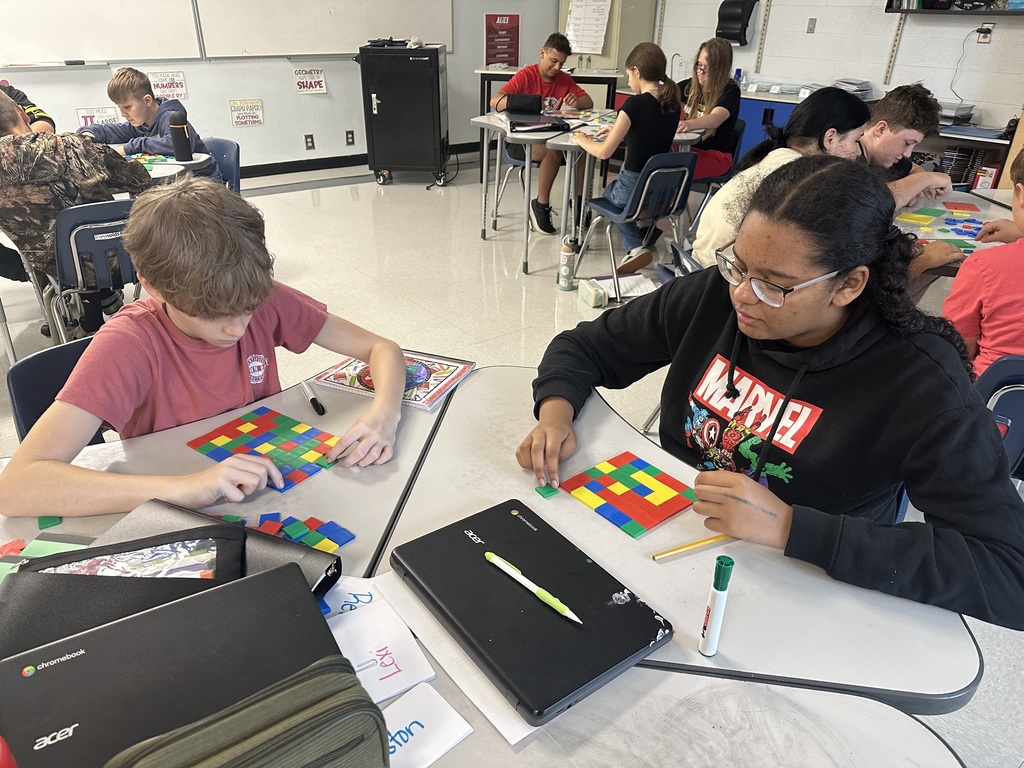 Students create perfect squares with tiles.