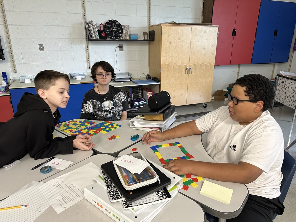 Students create perfect squares with tiles.