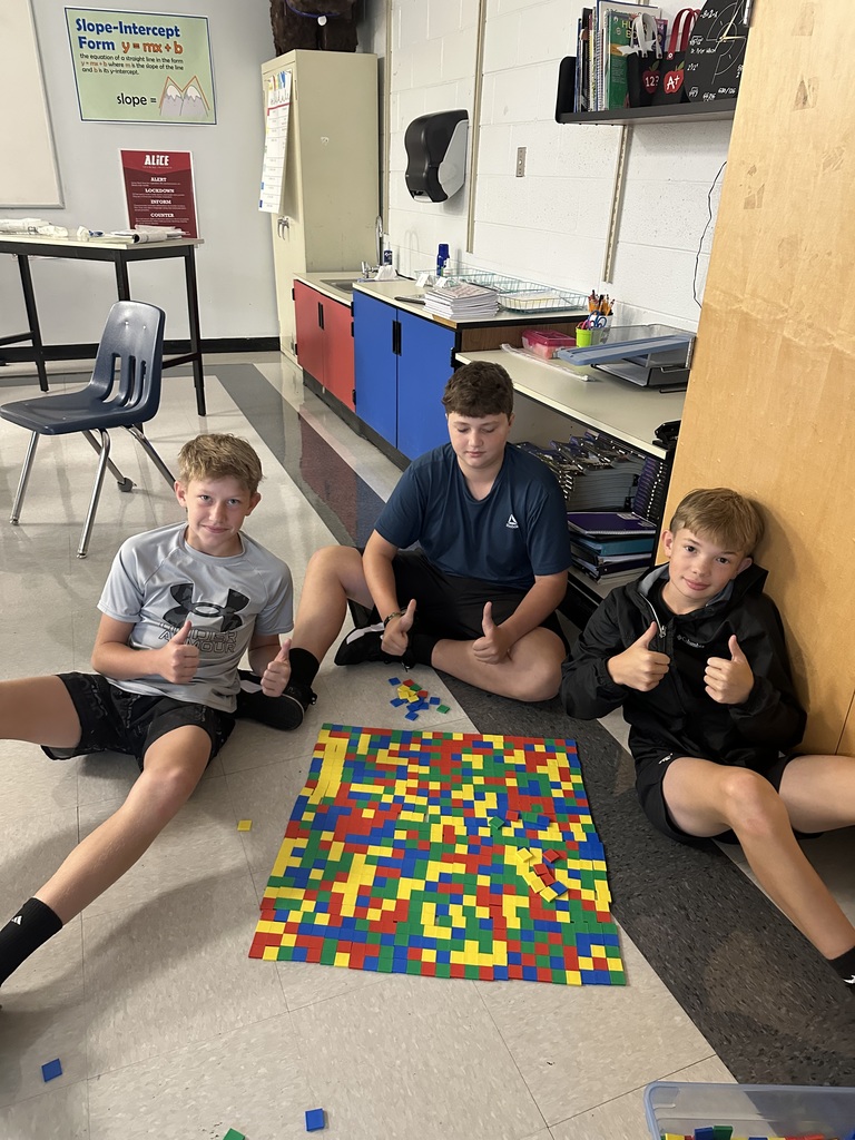 Students create perfect squares with tiles.