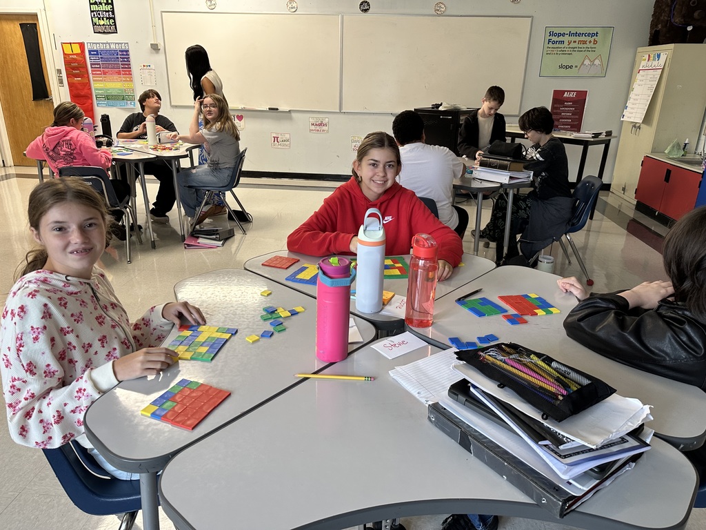 Students create perfect squares with tiles.