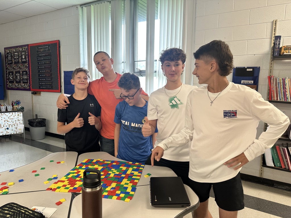 Students create perfect squares with tiles.