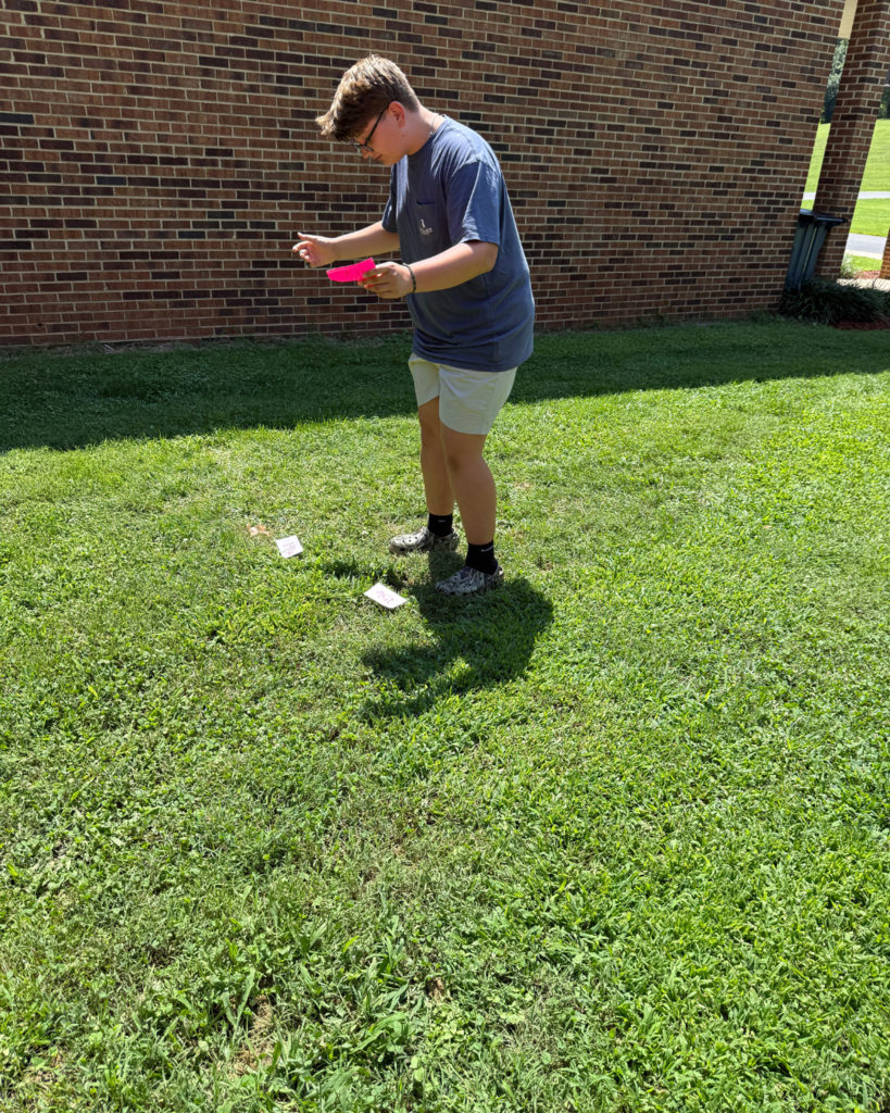 A student matches a perfect square to a square root.