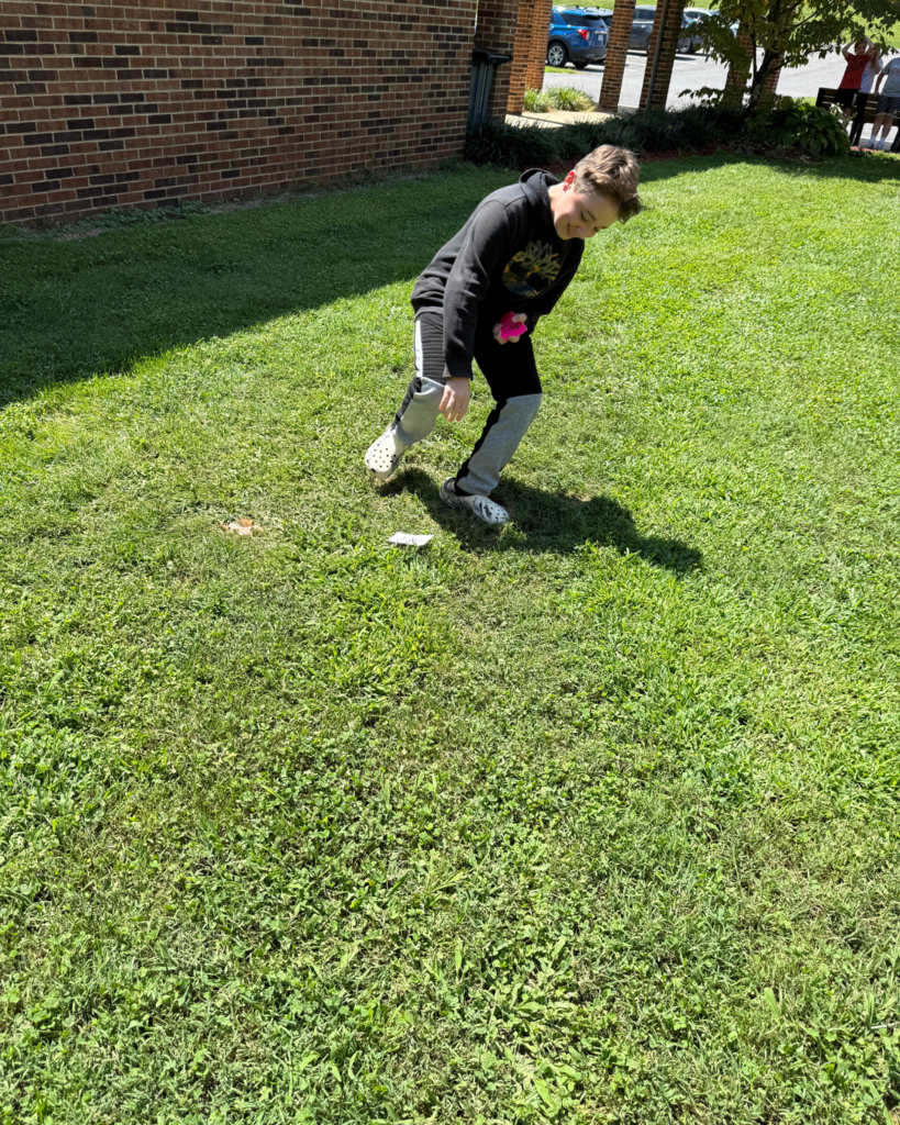A student matches a perfect square to a square root.