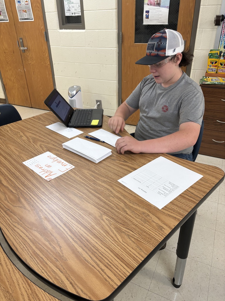 A student addresses an envelope.