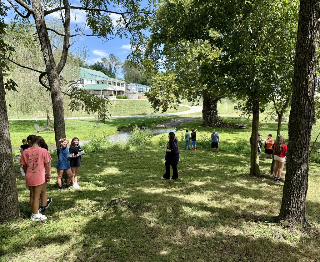 Students explore an area of farmland next to a creek.