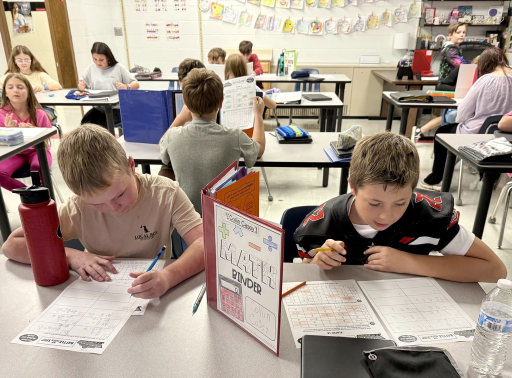 Students play a math game in a classroom.