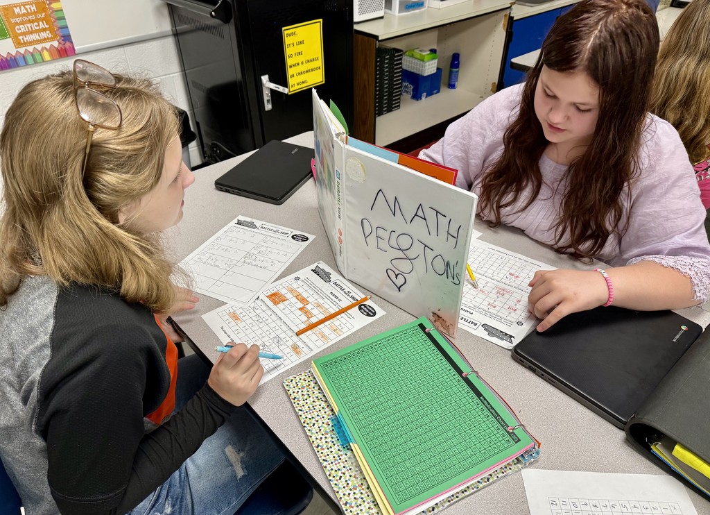 Students play a math game in a classroom.