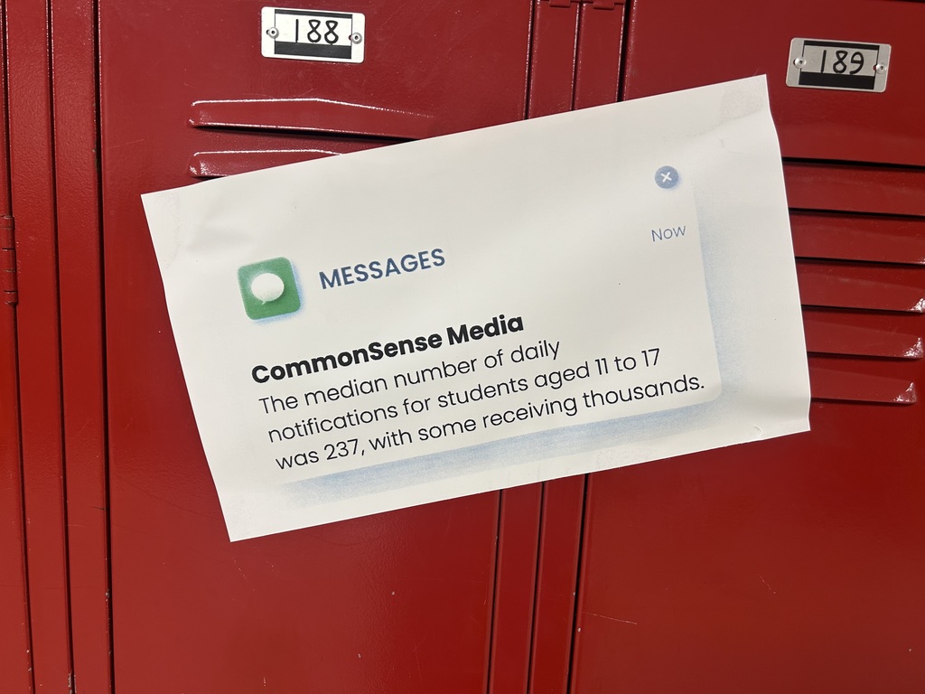 A poster with statistics from CommonSense Media hangs in a hall.