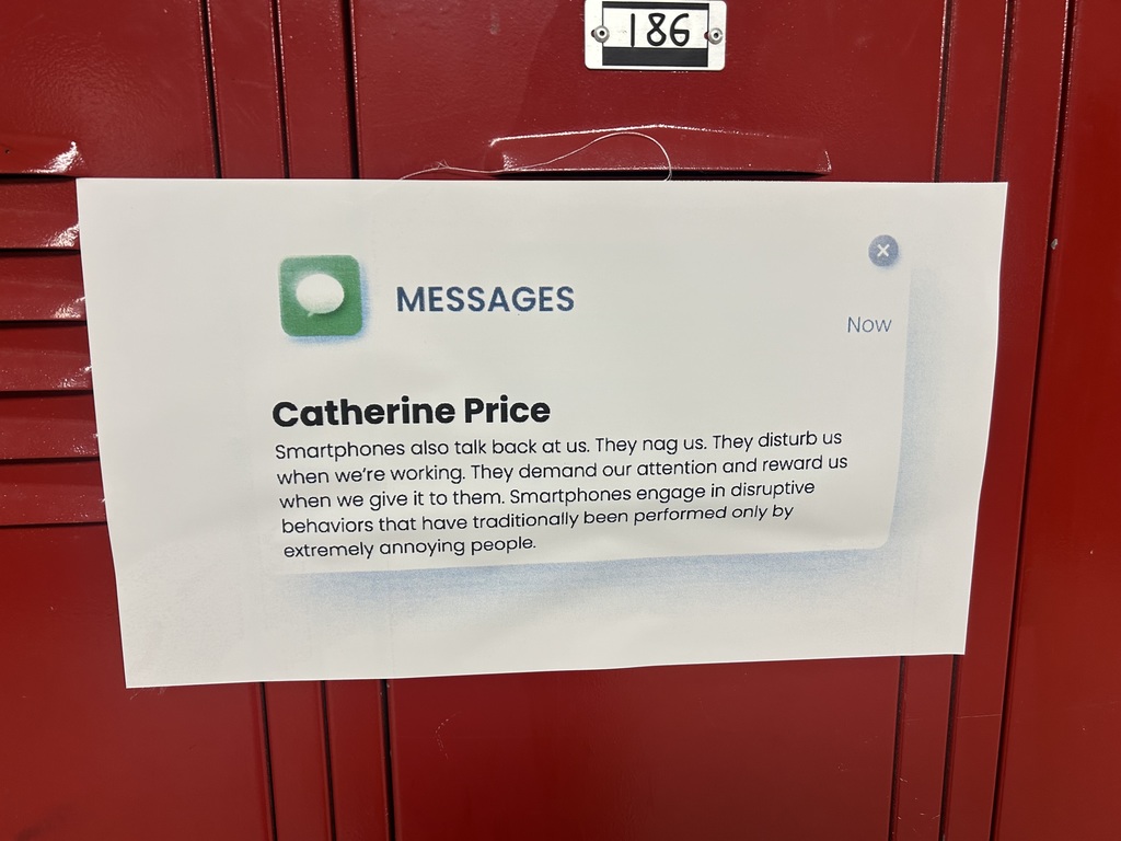 A quote from Catherine Price on a poster hangs in a hall.
