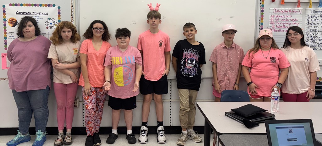 A group of people wear pink for Homecoming dress-up days.