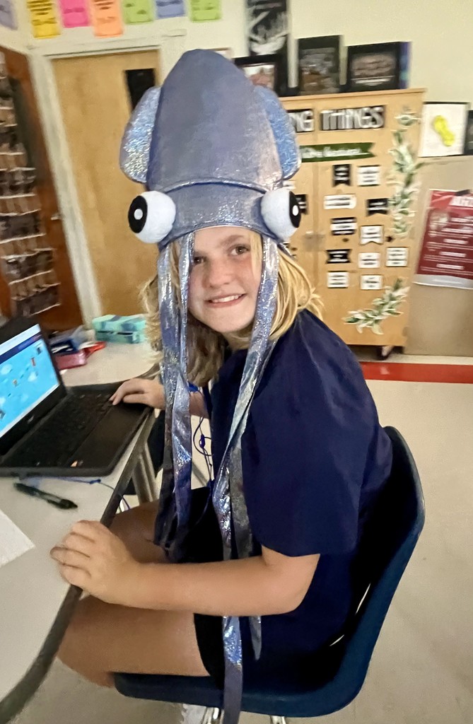 A student in costume poses in a school.