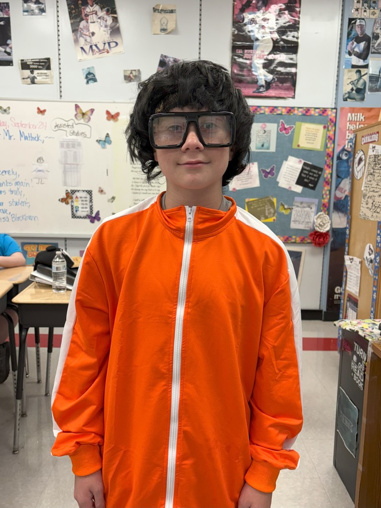 A student in costume poses in a school.
