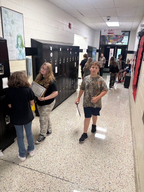 Students dressed in camo work on math problems.