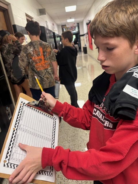 Students dressed in camo work on math problems.