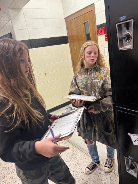 Students dressed in camo work on math problems.