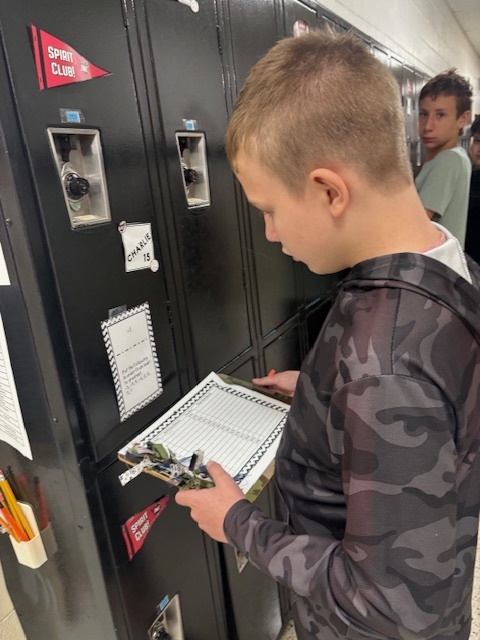 Students dressed in camo work on math problems.