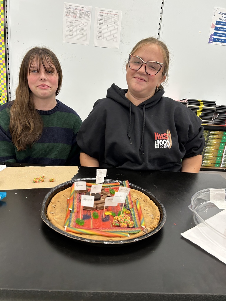Students display their edible cell project.